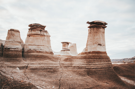 Art and Photography by Diana - Artwork - Columns of Earth, Drumheller, located in Southern Alberta - As rain washes away dirt and wind swirls around rocks, the hoodoos rise above all else